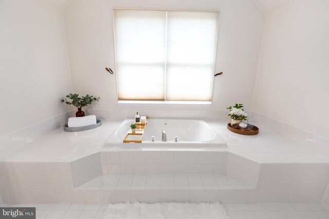 bathroom with tiled tub