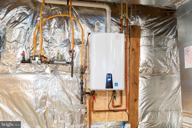 utility room featuring tankless water heater