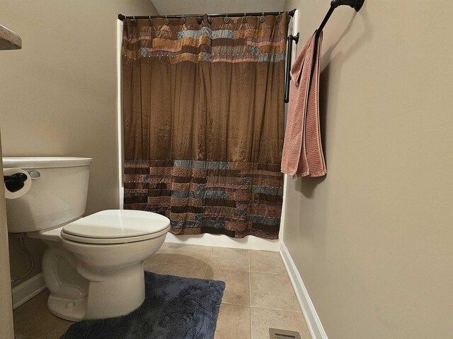 full bath with tile patterned floors, baseboards, a shower with shower curtain, and toilet