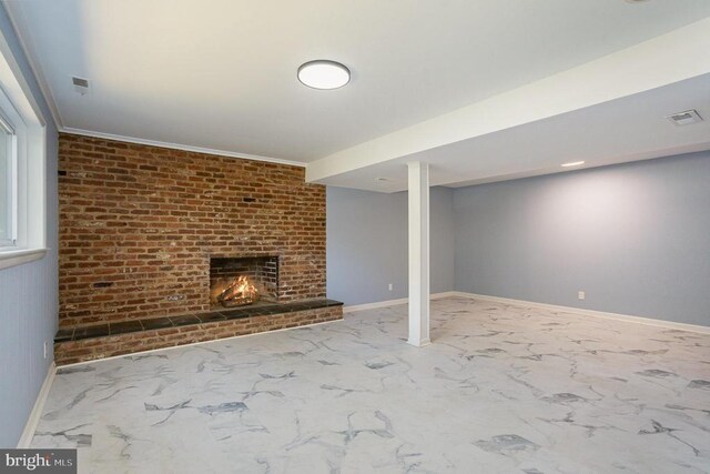 basement featuring a brick fireplace