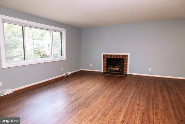 unfurnished living room featuring a fireplace and hardwood / wood-style floors