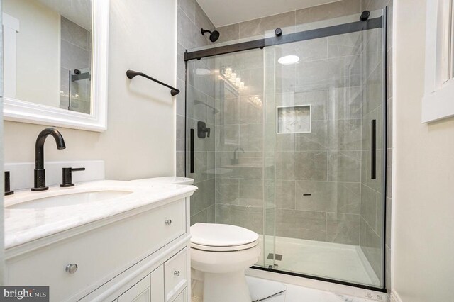 bathroom with vanity, toilet, and walk in shower