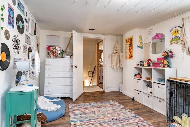 playroom featuring baseboards and dark wood-style flooring