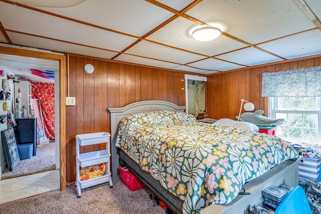 carpeted bedroom with wood walls