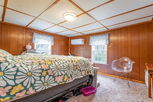 bedroom featuring wooden walls, a wall mounted air conditioner, carpet floors, and multiple windows