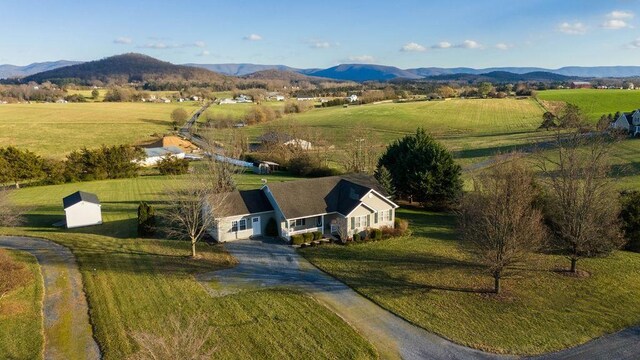 birds eye view of property featuring a mountain view and a rural view