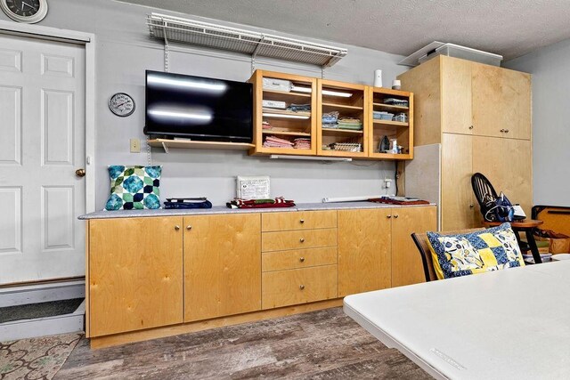 kitchen featuring dark wood-type flooring and a textured ceiling