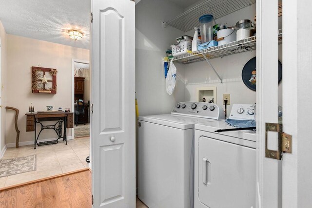 laundry room with hardwood / wood-style flooring and washer and dryer