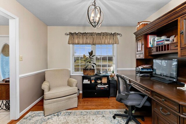 office area with a chandelier and light hardwood / wood-style floors