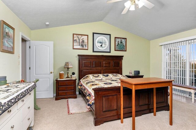 carpeted bedroom featuring lofted ceiling and ceiling fan