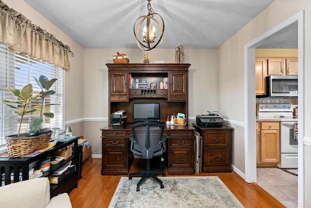 office featuring a chandelier and light hardwood / wood-style floors