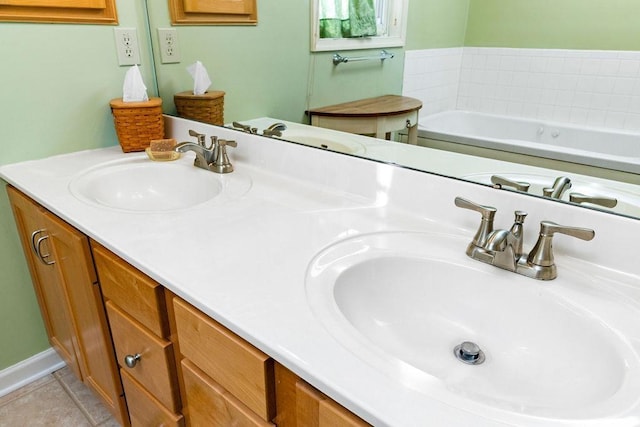 bathroom featuring vanity, a bath, and tile patterned floors