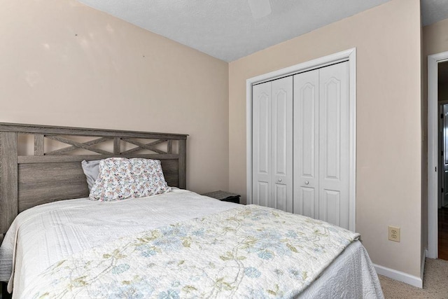 carpeted bedroom with ceiling fan and a closet