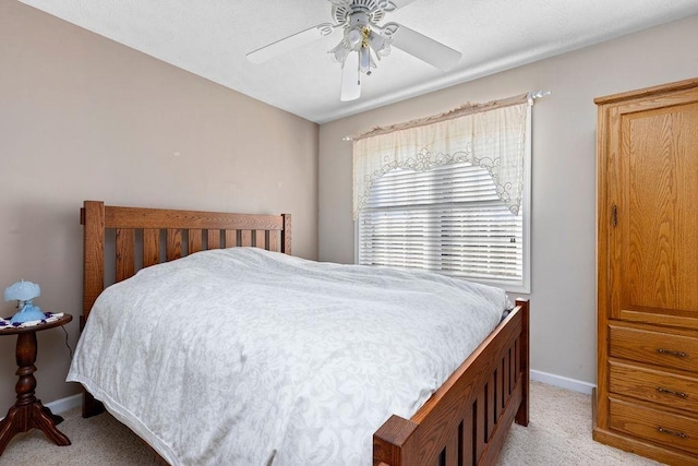 bedroom with light colored carpet and ceiling fan