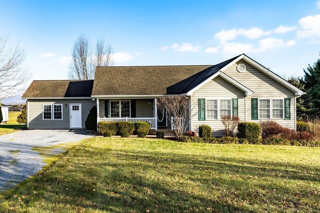 ranch-style house with a front yard and a porch