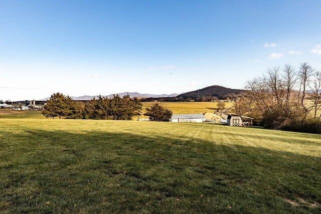 view of yard featuring a mountain view and a rural view