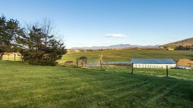 view of yard with a mountain view and a rural view