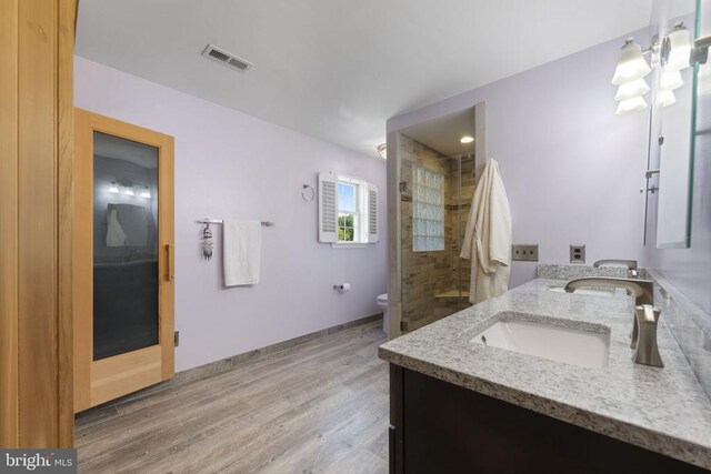 bathroom with vanity, an enclosed shower, hardwood / wood-style flooring, and toilet