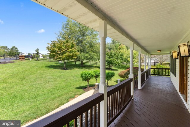 deck with a yard and covered porch