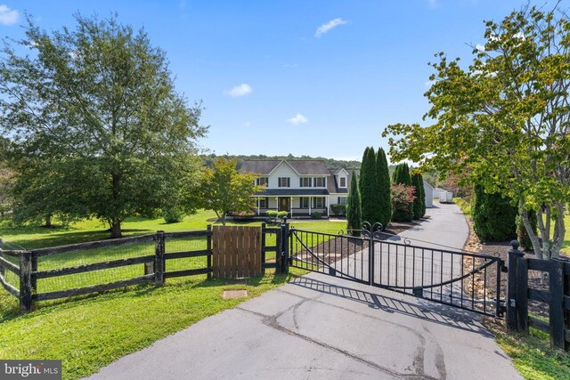 view of gate featuring a yard