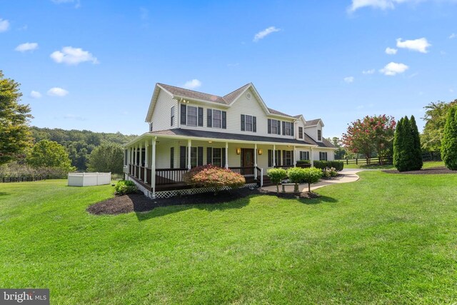 country-style home with covered porch and a front yard