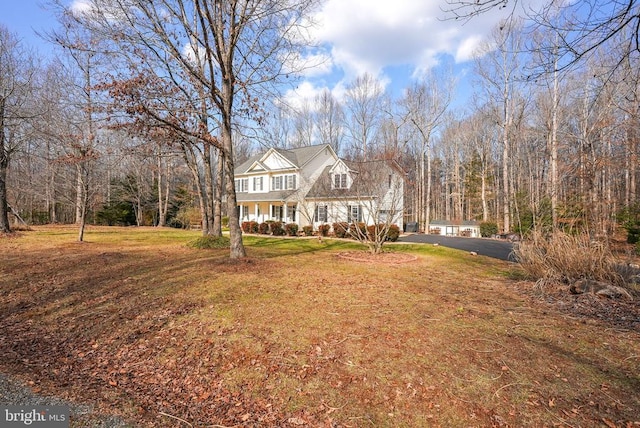 view of front of house featuring a front yard and covered porch