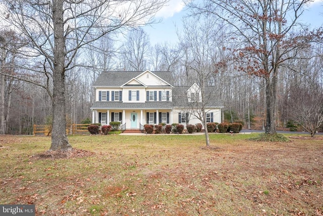 view of front of house with a porch and a front lawn