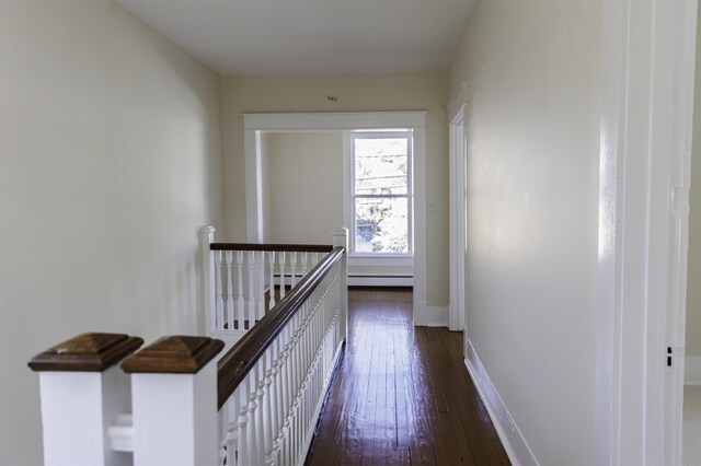 hall featuring dark hardwood / wood-style flooring and baseboard heating