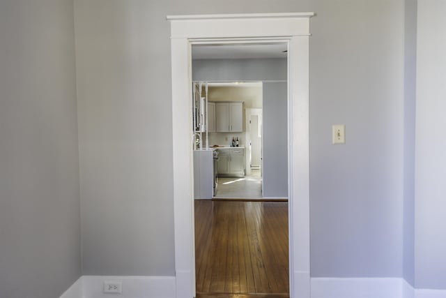 hall with hardwood / wood-style floors