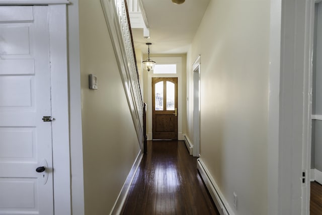 doorway featuring dark hardwood / wood-style floors and a baseboard heating unit