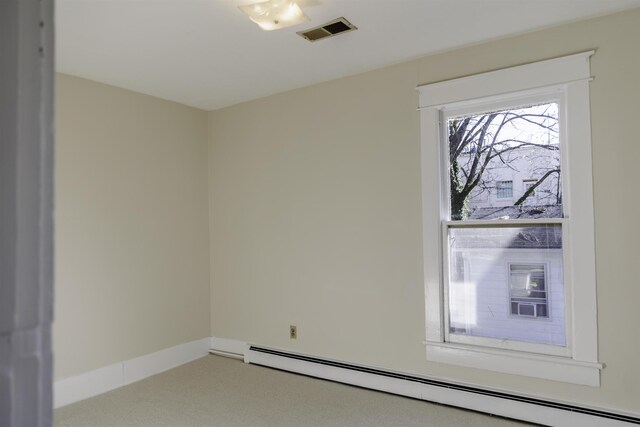 carpeted empty room with baseboard heating