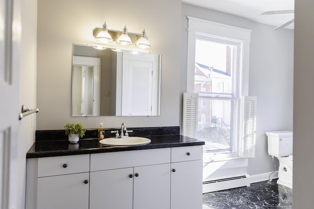 bathroom with vanity, a baseboard radiator, and toilet