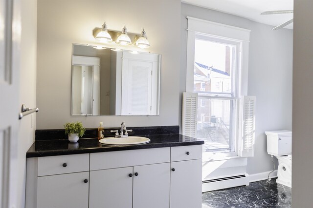 bathroom with vanity, a baseboard radiator, and toilet