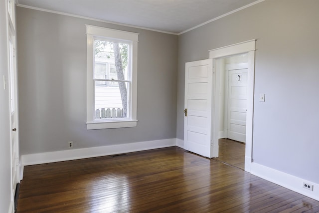 unfurnished bedroom featuring dark wood-type flooring and crown molding