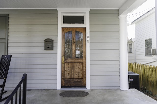 view of exterior entry with central air condition unit