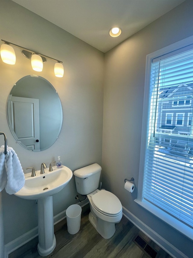 bathroom with wood-type flooring and toilet