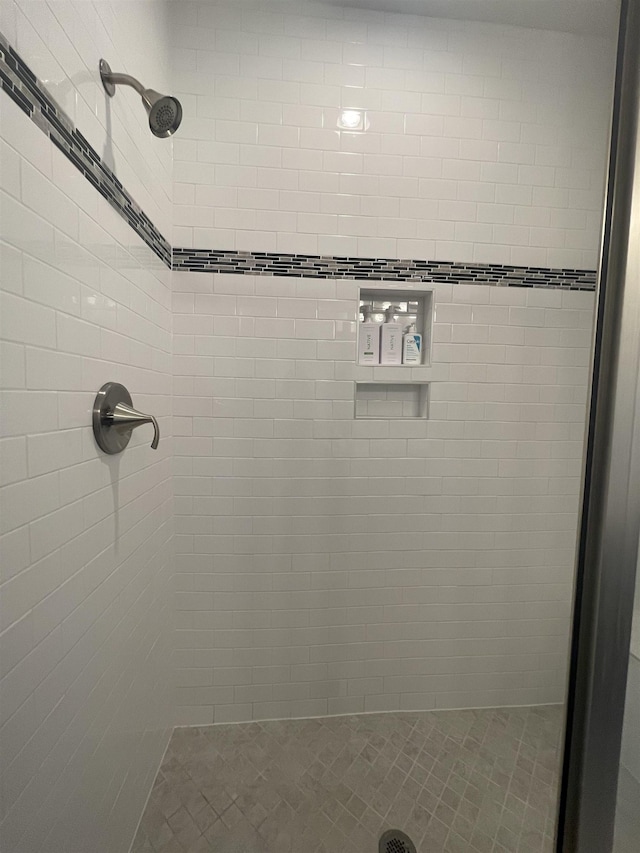 bathroom with a tile shower