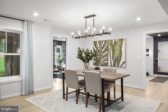 dining room with a notable chandelier and light hardwood / wood-style flooring