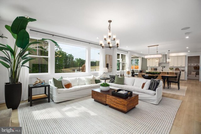 living room featuring an inviting chandelier and light hardwood / wood-style floors