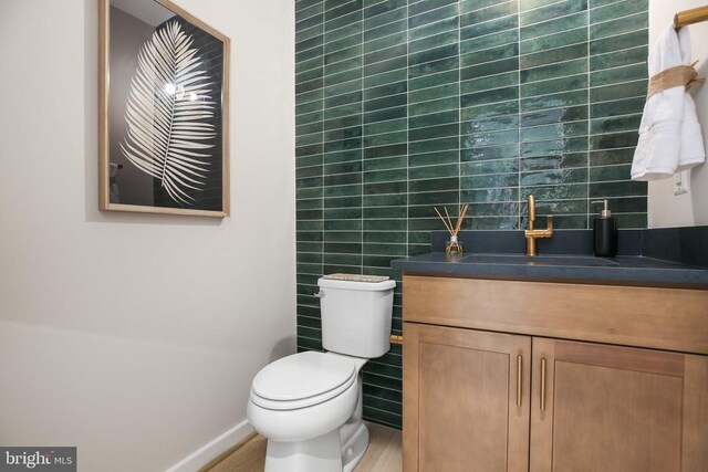 bathroom featuring hardwood / wood-style flooring, vanity, and toilet