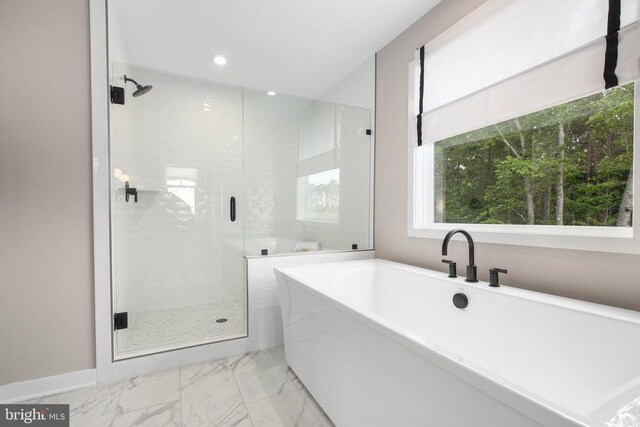 bathroom featuring separate shower and tub