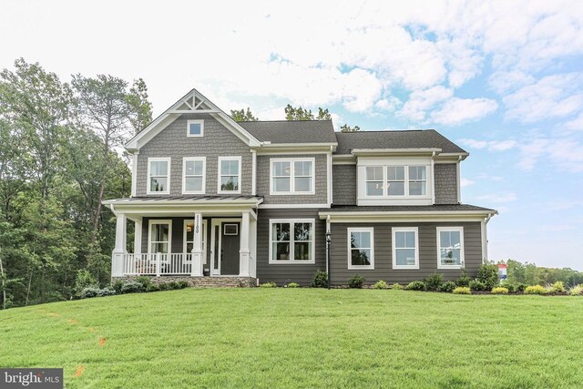 view of front of house with covered porch and a front lawn