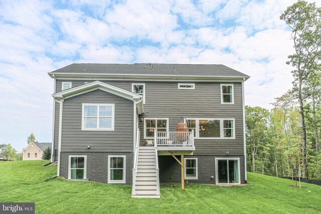 back of house with a deck and a lawn