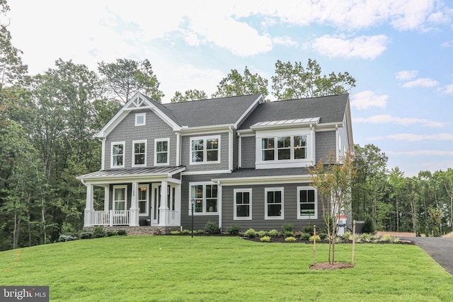 craftsman house with covered porch and a front yard