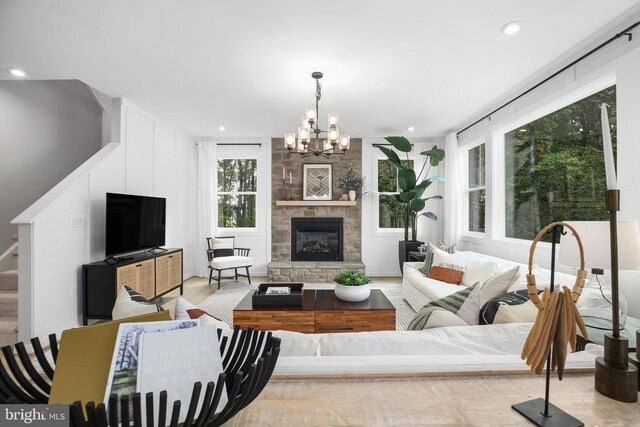 living room featuring a fireplace and a chandelier