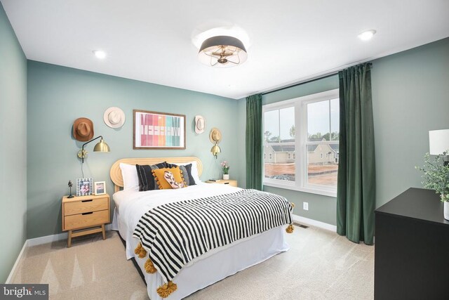 bedroom with light colored carpet