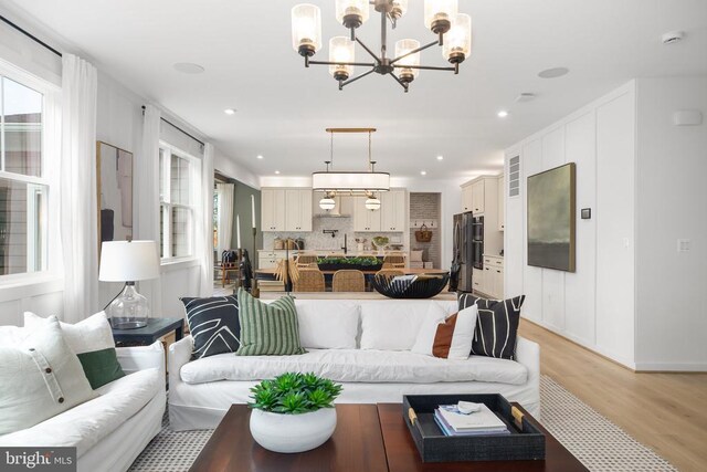 living room featuring sink and light wood-type flooring