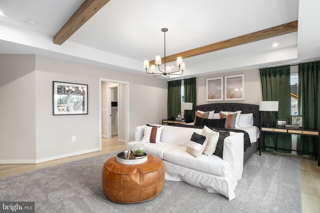 bedroom featuring beamed ceiling, a raised ceiling, hardwood / wood-style floors, and an inviting chandelier