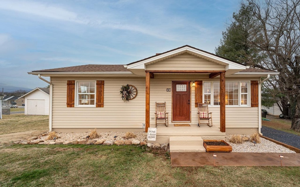 bungalow-style house with a front lawn and a porch