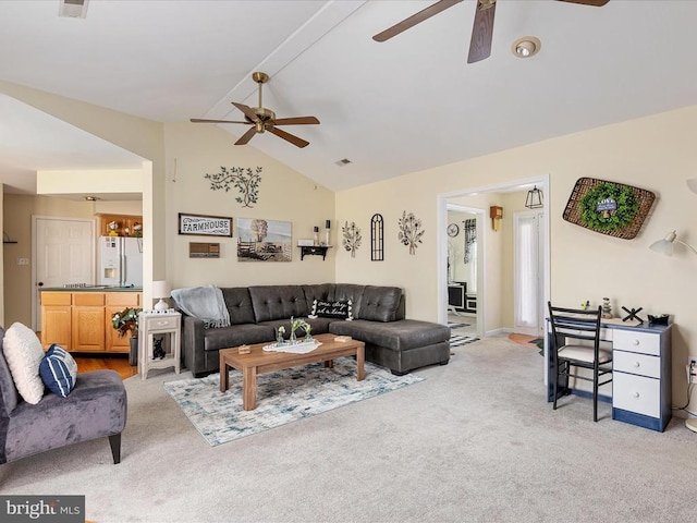 carpeted living room featuring ceiling fan and vaulted ceiling